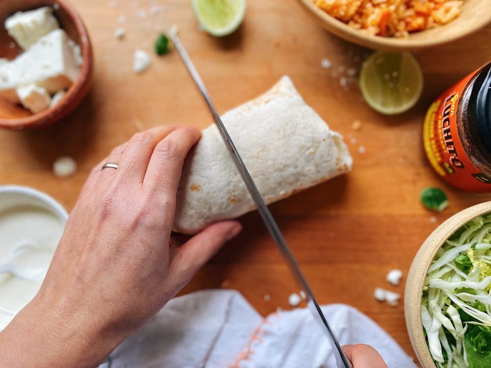 chopping a burrito in half