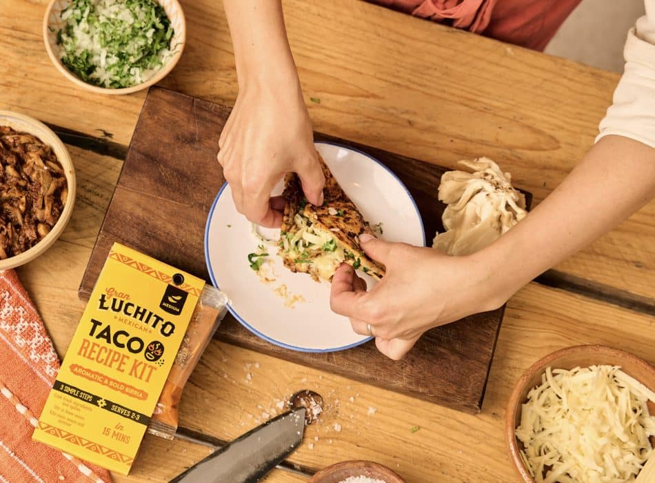Mushroom birria holding soft tacos